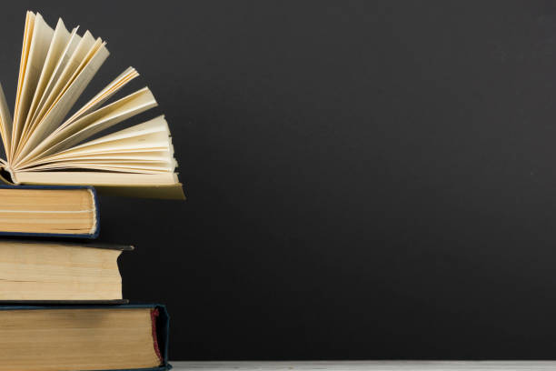 istock Open book, hardback books on wooden table. Back to school. Copy space. 1136656192