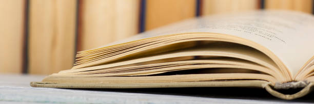 istock Open book, hardback books on wooden table. Back to school. Copy space. 1136656226
