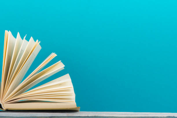 istock Open book, hardback books on wooden table. Back to school. Copy space. 1136656242