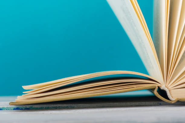 istock Open book, hardback books on wooden table. Back to school. Copy space. 1136656262