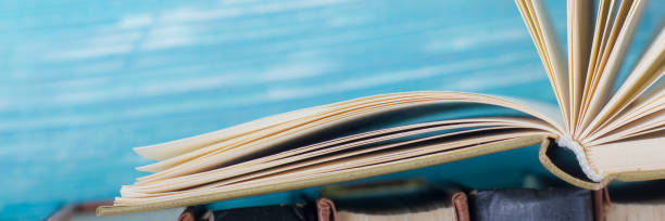 istock Open book, hardback books on wooden table. Back to school. Copy space. 1136656270