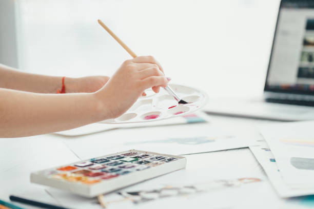 istock The hand working with an art brush and paints 1136656318