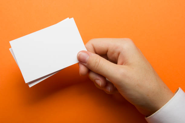 istock Hand holding white business card on white background 1136656343
