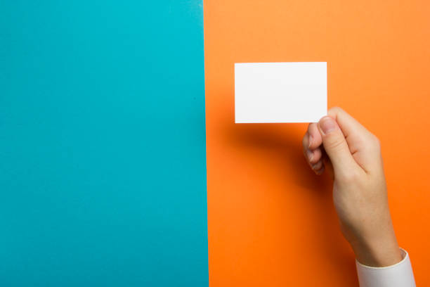 istock Hand holding white business card on white background 1136656354