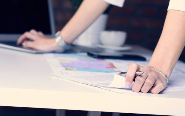 istock Real estate creative studio office. Architect woman working on architectural project for interior design. Woman's hands over the table with the drawing. 1136656408