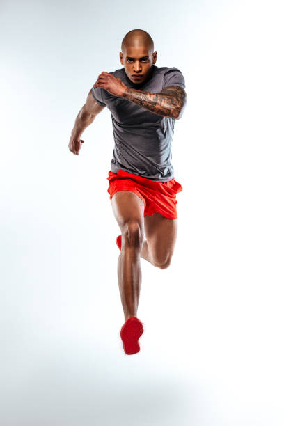 istock Runner wearing sportsuit demonstrating his muscles power 1136658287