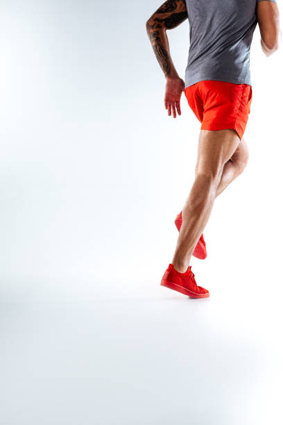 istock Man wearing red shorts and snickers is running 1136658305