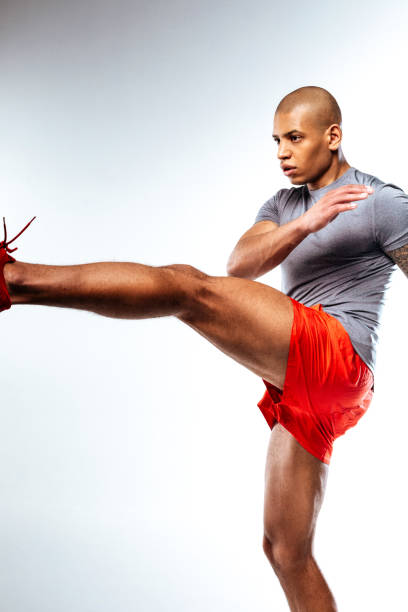istock Sportive bold man moving his leg upwards 1136658313