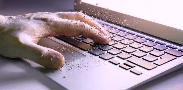 Dissolving texture of human hand working with laptop computer