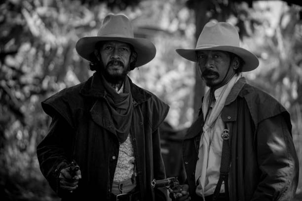 Close up Two cowboys standing and holding short gun in his farm