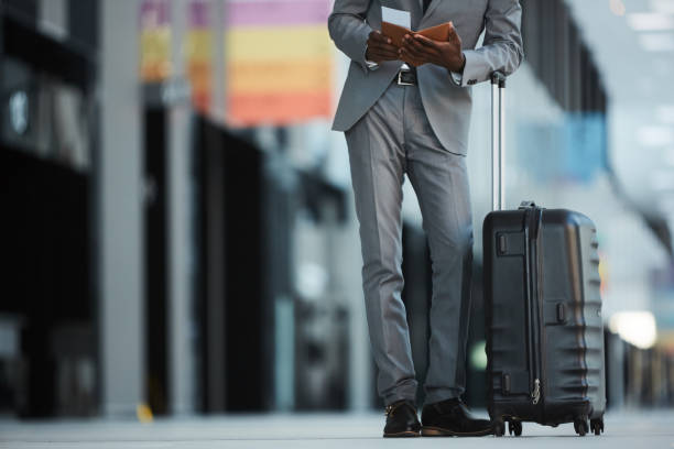 istock Crop black businessman checking passport and tickets 1136659326
