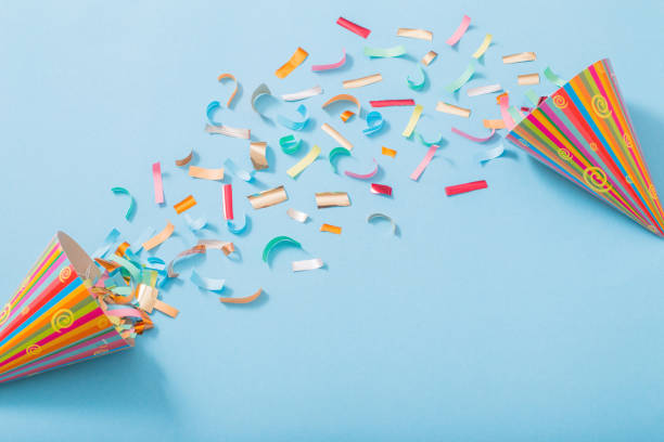 istock birthday hat with confetti on paper background 1136659576