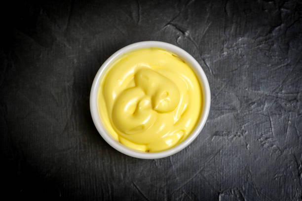 istock Cheese sauce in a gravy boat. Photo on a dark background. 1136659699