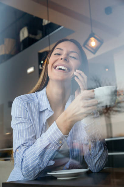 istock Woman speaking on the phone and drinking coffee 1136660812