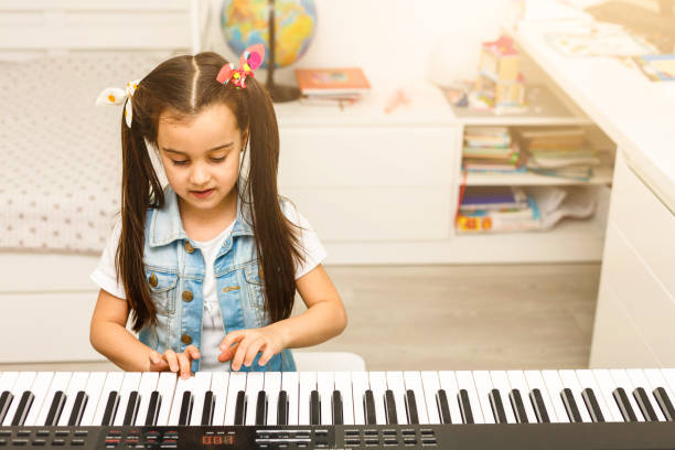 istock girl long hair practicing piano 1136661066