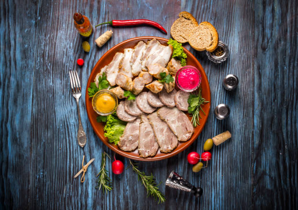 istock Snack set. Assorted sliced meat with spices on rustic wooden background 1136661628