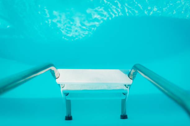 istock blue outdoor pool in the garden surrounded by trees 1136662400