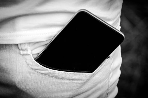 istock Mobile phone in pocket white jeans. Place for your text. 1136662981