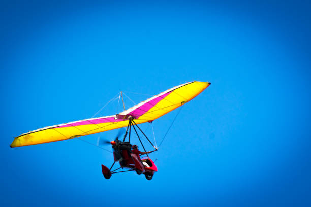 Flying a trike high in the blue sky. Flying a trike high in the blue sky. Flying a trike high in the blue sky. para ascending stock pictures, royalty-free photos & images