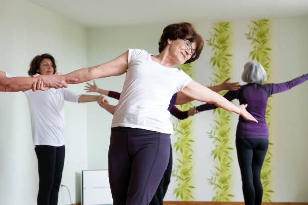 istock Senior women practicing  yoga in yoga studio 1136665196