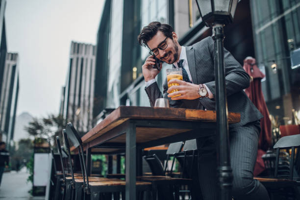 istock Cheerful businessman drinking beer and talking on smart phone 1136666507