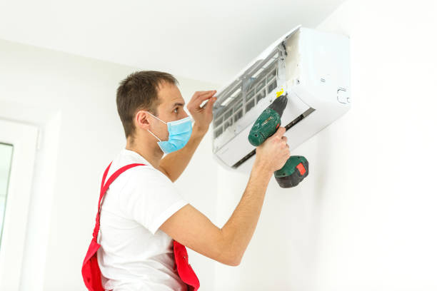 istock Male technician cleaning air conditioner indoors 1136667501