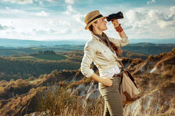 istock smiling woman looking into distance through binoculars 1136667973