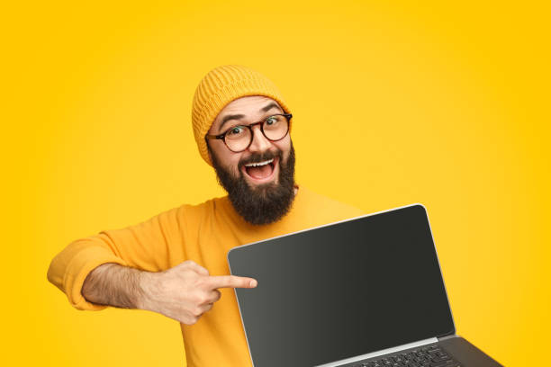istock Bright man pointing at modern laptop 1136668089