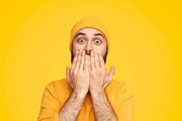 istock Amazed shocked man covering face 1136668092