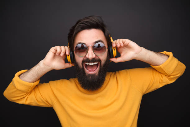 istock Rebel hipster man in headphones screaming 1136668095