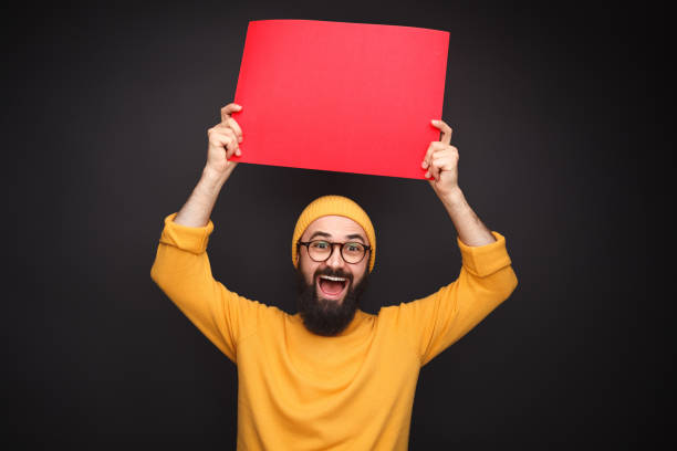 istock Cheerful hipster with red poster 1136668123