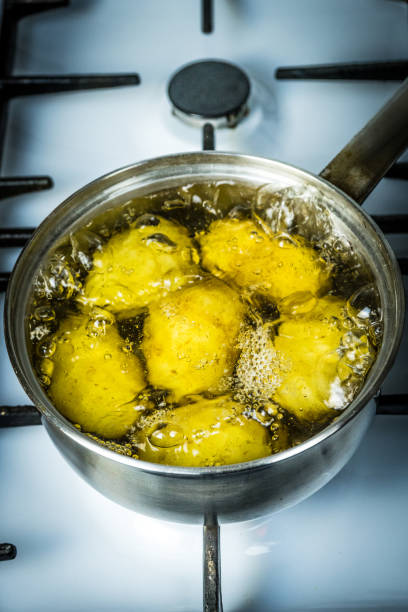 istock potatoes boil in water and a saucepan. place for your text. 1136669251