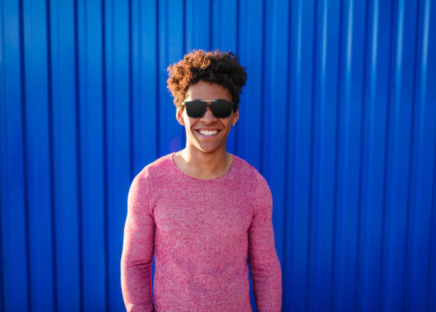istock Contemporary ethnic guy in sunglasses smiling at camera 1136669388