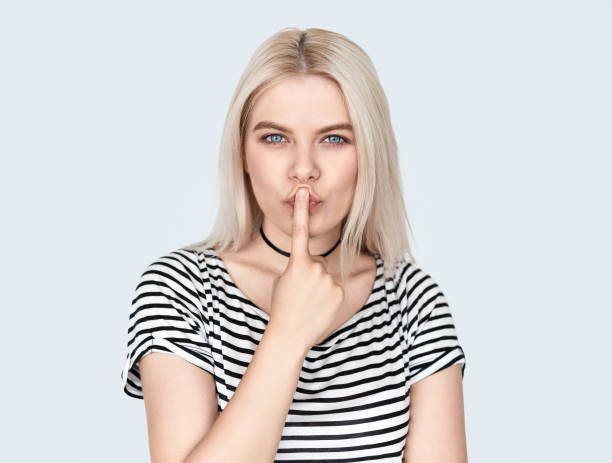 istock Modern girl pressing lips with finger 1136669414