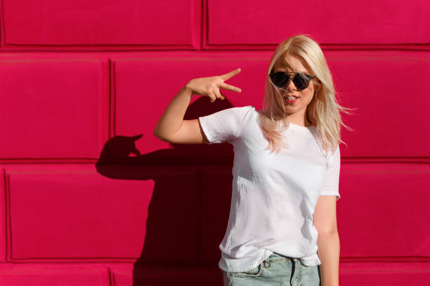 istock Contemporary blonde showing two fingers 1136669447