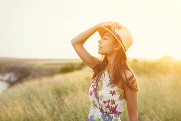istock Sensual young woman in straw hat in sunlight 1136669470