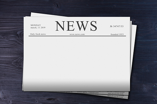 pack of News newspapers with copy space on dark table background