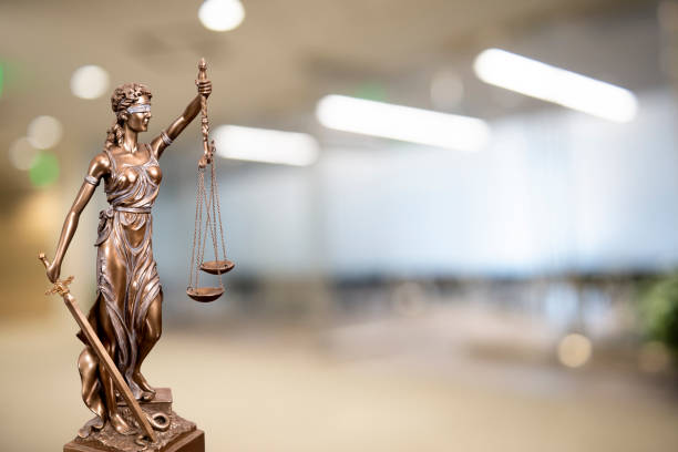 istock Lady Justice Statue with Defocused Office Background 1136673157