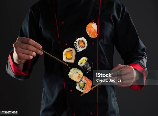 Master Chef Holding Chopsticks With Flying Sushi Stock Photo - Download Image Now - Chef, Sushi, East Asian Culture