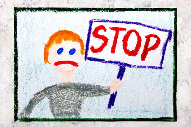 istock Colorful drawing: Sad boy holding a STOP sign in his hand 1136676935