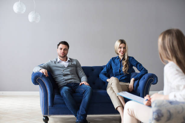 istock Happy young couple visiting psychologist for family problem. 1136678401