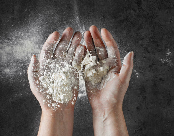 istock bakers hand with flour in motion on black kitcen table 1136680805