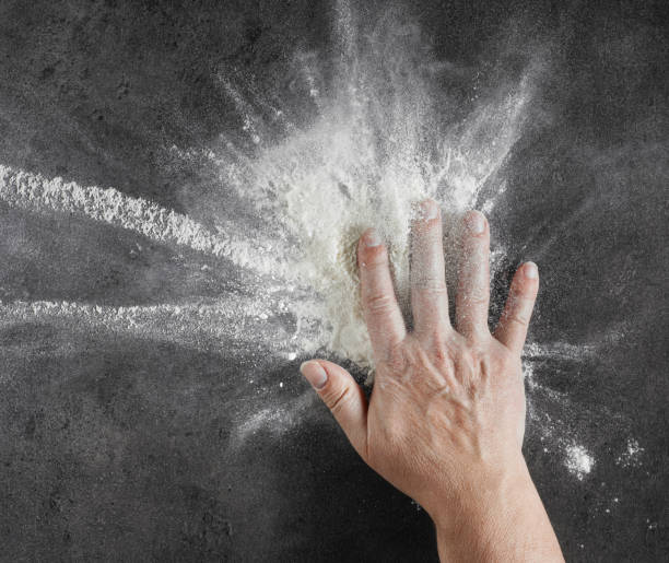 istock bakers hand with flour in motion on black kitcen table 1136680812