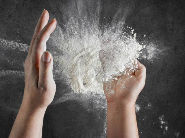 istock bakers hand with flour in motion on black kitcen table 1136680820