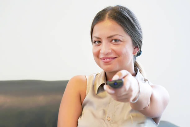 istock Young girl watching tv on sofa 1136681714