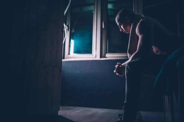 istock Tired bodybuilder sitting at the locker room 1136682265