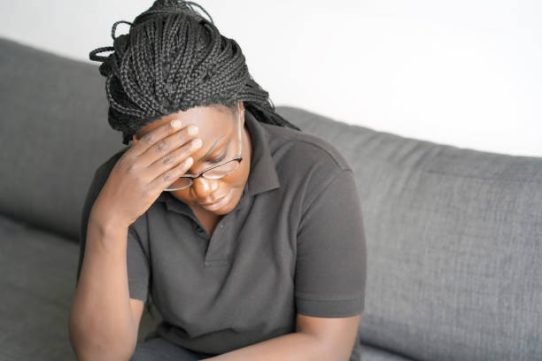 istock Woman headache squeezes her head 1136682961