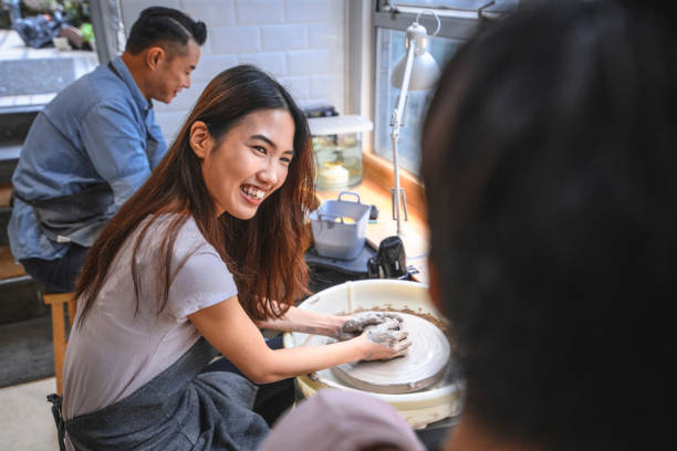 istock Males and females learning in pottery workshop 1136683239
