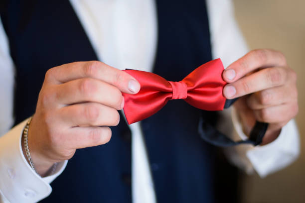 istock The groom dresses for the ceremony. 1136685412