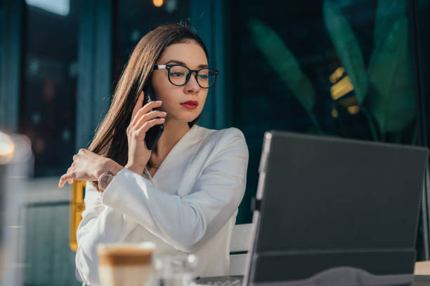 istock Elegant woman with eyeglasses is having a phone call 1136686713